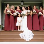 Bridal party on the front porch of a chic rustic wedding