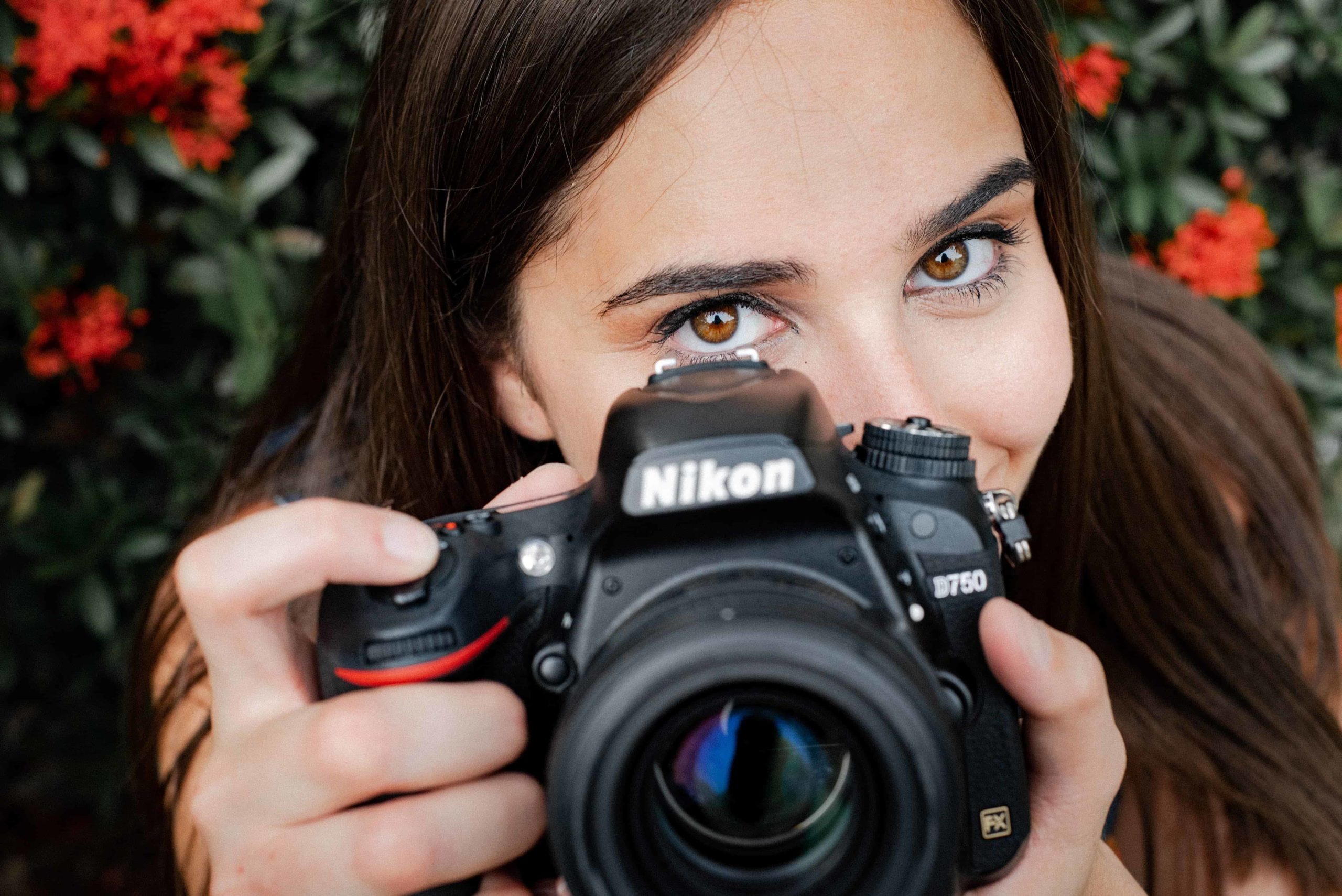 Photographer holding a DSLR camera to her face