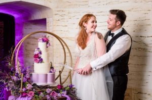 Bride and Groom Cutting Wedding Cake at Styled Shoot