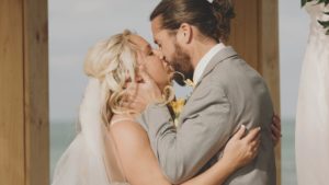 Couple kissing at beach wedding at Radisson Suite Hotel Oceanfront