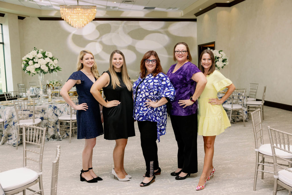 Orlando wedding planners from Just Marry! standing in a wedding reception room