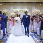 Haitian couple walking down the aisle during the wedding recessional