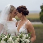 Lesbian couple touching foreheads in a marsh