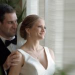 Jewish groom touching bride's shoulders at their Opal Sands wedding