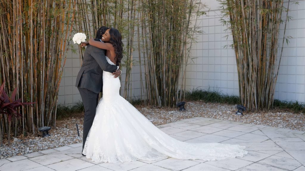 Haitian bride and groom hugging outside during their first look at B Resort & Spa