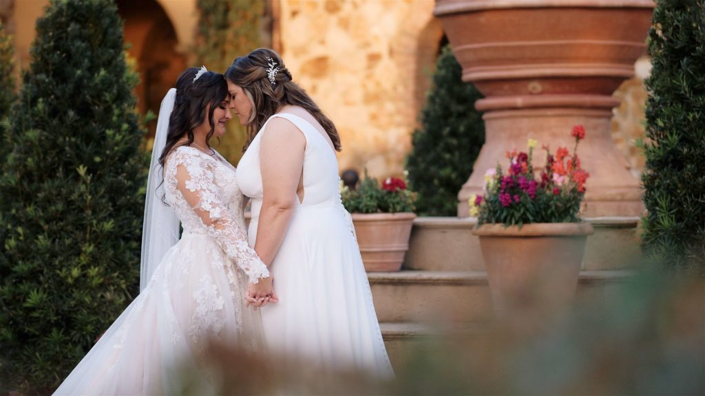 Two brides kissing at Bella Collina
