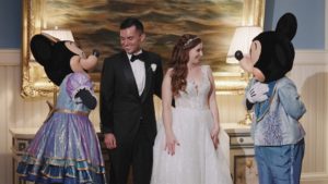 Bride and groom smiling with Mickey and Minnie characters at Boardwalk Inn after the Disney Wedding Pavilion ceremony