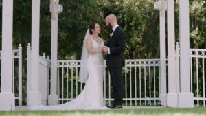 Bride and Groom standing on a sidewalk behind Lake Mary Events Center